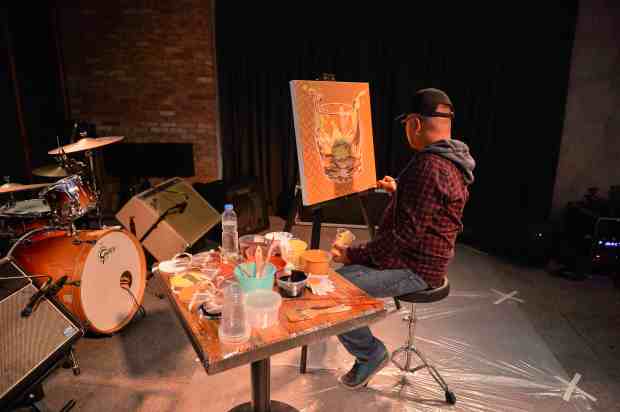 Award-winning local artist Archie Oclos interpreting the complexity of whisky in a live painting session.jpg